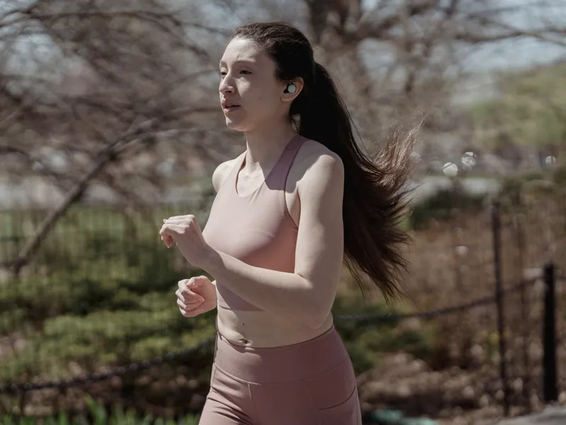 Runner wearing wireless earbuds outdoors